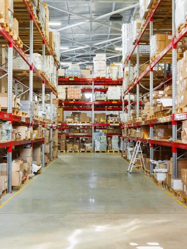 Modern warehouse shelves with pile of cardboard boxes